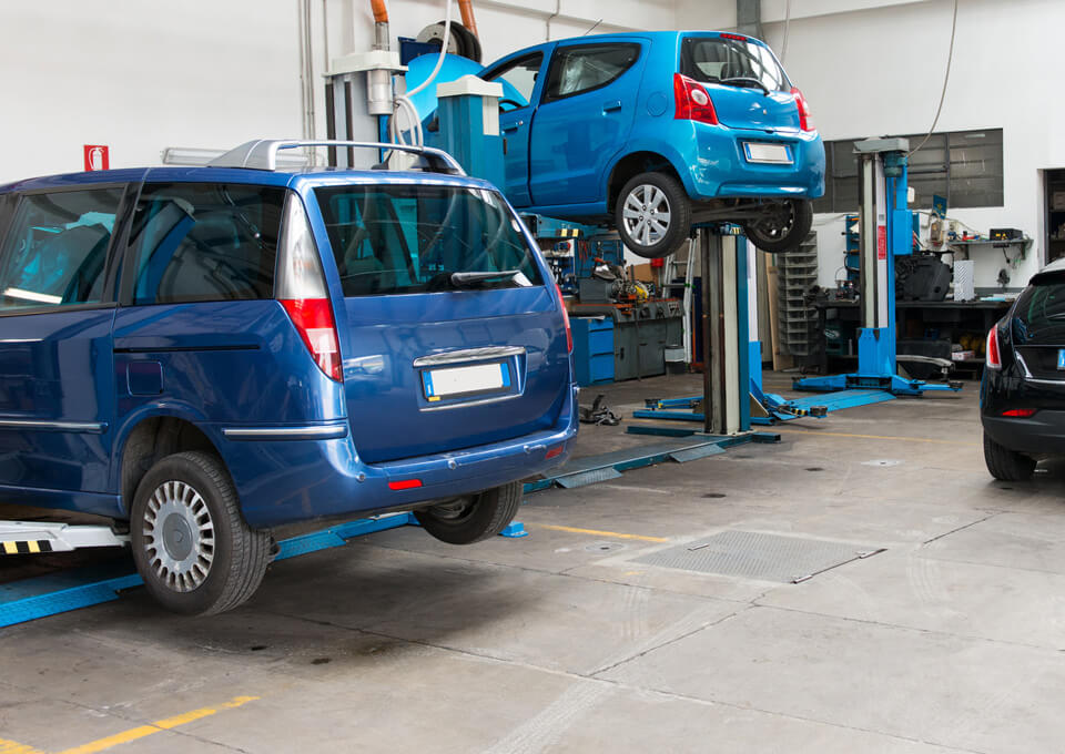 Mechanics servicing a car